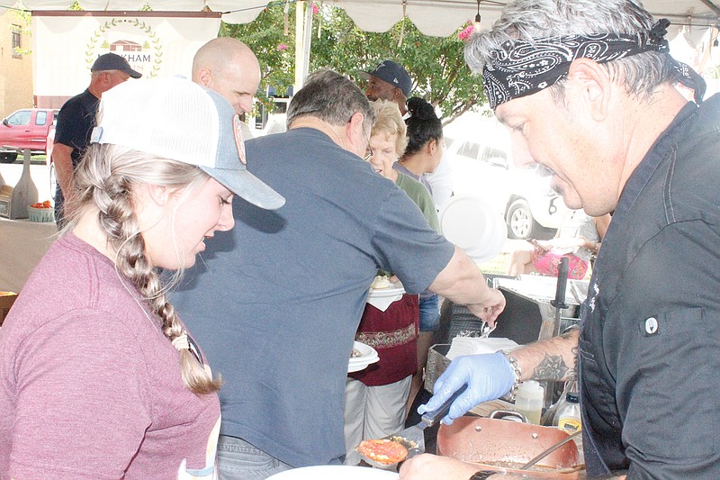  Jeff Loving, local chef and operator of Chef On the Run, serves breakfast to hungry shoppers at the last day of this year's Texarkana Farmers' Market. The feast featured all local ingredients, all prepared on the premises.