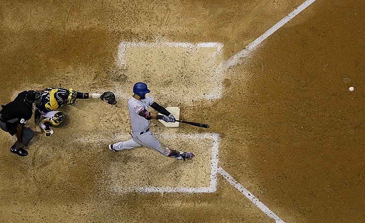 Texas Rangers' Nomar Mazara hits a single during the ninth inning of a baseball game against the Milwaukee Brewers Saturday, Aug. 10, 2019, in Milwaukee. (AP Photo/Morry Gash)