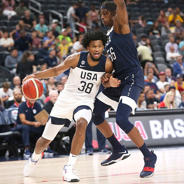Team White forward Marvin Bagley III (left) dribbles the ball under pressure from Team Blue center Myles Turner during the first half of the U.S. men's basketball team's scrimmage Friday in Las Vegas.