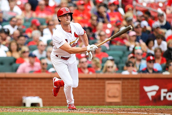Lane Thomas of the Cardinals follows through on an RBI triple during the fourth inning of Sunday afternoon's game against the Pirates at Busch Stadium.
