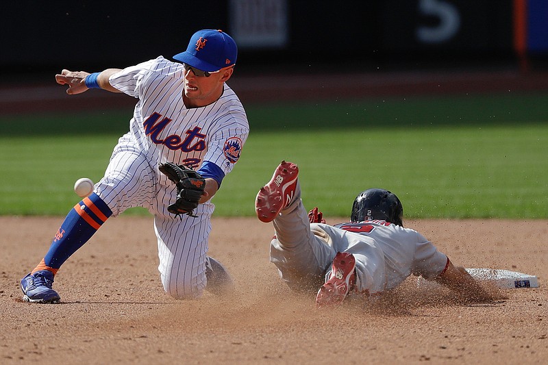  Washington Nationals' Adam Eaton, right, slides past New York Mets' Joe Panik to steal second base during the ninth inning of a baseball game Sunday in New York. 