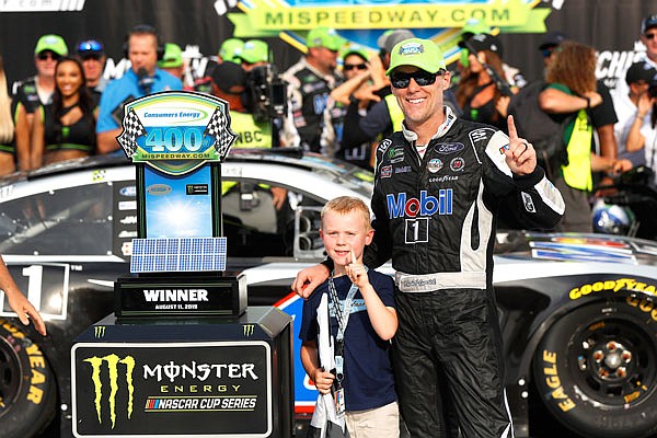 Kevin Harvick celebrates with his son, Keelan, after winning Sunday's NASCAR Cup Series race at Michigan International Speedway in Brooklyn, Mich.