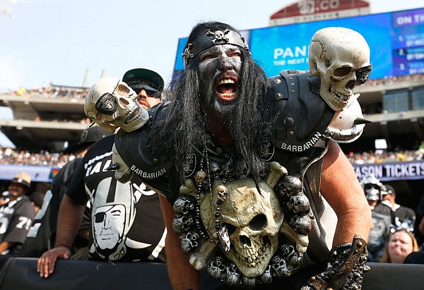 In this Sept. 13, 2015, file photo, Raiders fans watch during the second half of a game between the Raiders and the Bengals in Oakland, Calif.