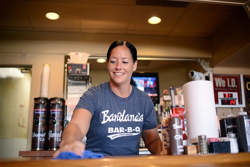 Sally Ince/ News Tribune
Gabby Jahr, of Russellville, wipes down the bar counter during her work shift Wednesday August 14, 2019 at Bandana's Bar-B-Q. Jahr is a single mother of four who is currently working 3 jobs while also working as a volunteer with Building Community Bridges.  