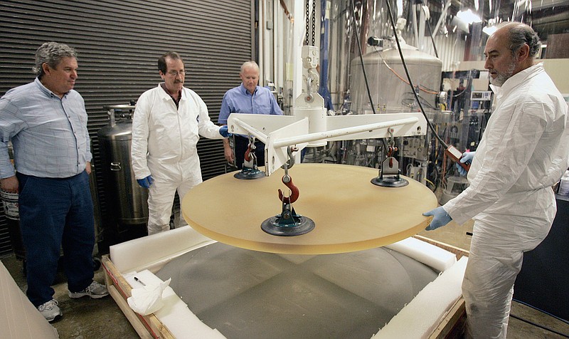  In this Jan. 7, 2008, file photo, Thirty Meter Telescope Project Scientist Jerry Nelson, left, and Telescope Optics Group Leader Eric Williams, third from left, inspect a 500 pound glass blank as it is removed from packing by Dave Hilyard, Chief Optician at University of California, right, and Brian Dupraw at the UC Observatory Optical Lab at the University of California at Santa Cruz, Calif. Astronomers across 11 observatories on Hawaii's tallest mountain Mauna Kea have cancelled more than 2,000 hours of telescope viewing over the past four weeks because a protest blocked a road to the summit. Astronomers said Friday, Aug. 9, 2019, they will attempt to resume observations but in some cases won't be able to make up the missed research. (AP Photo/Ben Margot, File)