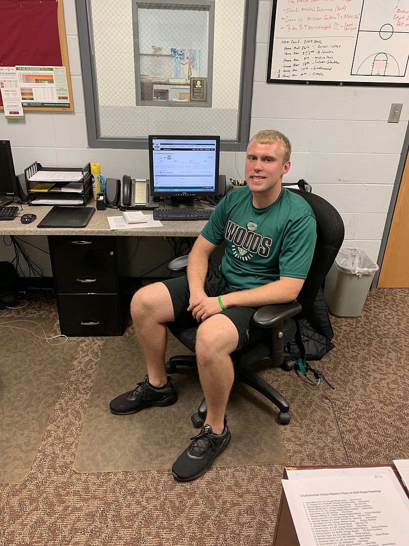 Zak Spryszak, William Woods University's new men's basketball graduate assistant coach, sits at his desk. Spryszak is a native of Troy, Michigan.