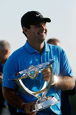Patrick Reed holds the FedEx Cup trophy Sunday after winning the Northern Trust at Liberty National Golf Course in Jersey City, N.J.