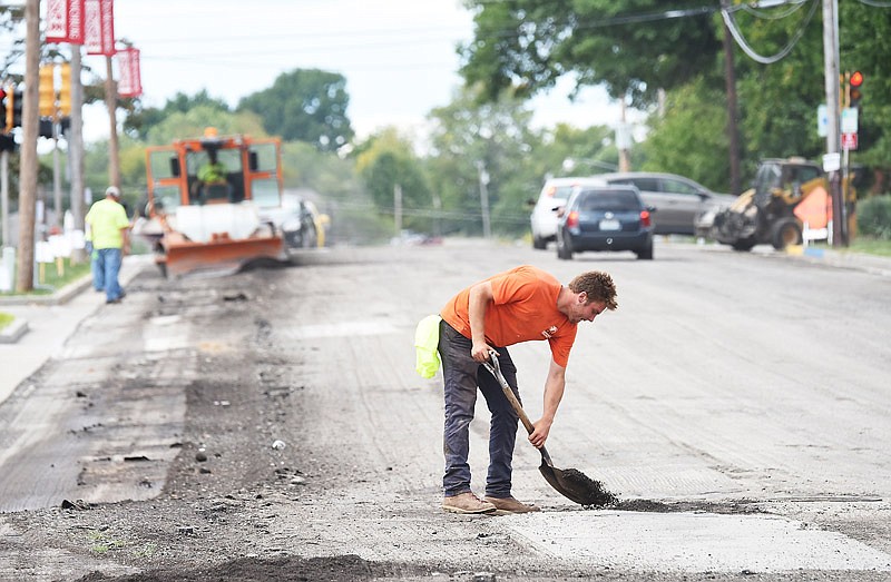 In this Oct. 1, 2018 photo, Gerrit Shirts spreads an asphalt mixture on Dunklin Street between Washington and Broadway streets during an initial part of a street overlay project.