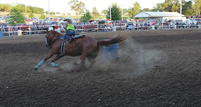 A rider hustles her way through a run at the barrel race at the 2019 Moniteau County Fair rodeo.