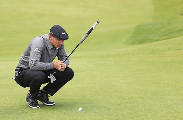 In this July 18 file photo, Bryson DeChambeau looks at his putt on the fourth green during the first round of the British Open at Royal Portrush in Northern Ireland.