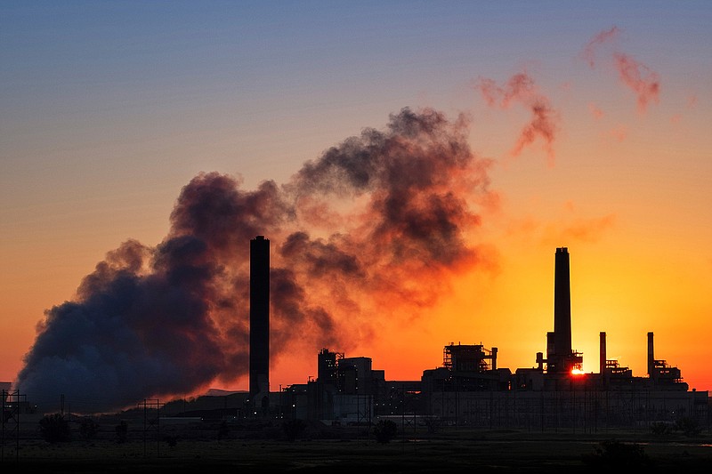 In this July 27, 2018, file photo, the Dave Johnson coal-fired power plant is silhouetted against the morning sun in Glenrock, Wyo. A coalition of 22 Democratic-led states has sued the Trump administration over its decision to ease restrictions on coal-fired power plants. The lawsuit, filed in the U.S. Court of Appeals for the District of Columbia Circuit, says the new rule violates the federal Clean Air Act because it does not meaningfully replace power plants' greenhouse gas emissions. (AP Photo/J. David Ake, File)