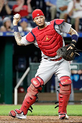 Cardinals catcher Yadier Molina throws to first after catching a pop fly for the out off the bat of Alex Gordon of the Royals during the ninth inning of Tuesday night's game at Kauffman Stadium.