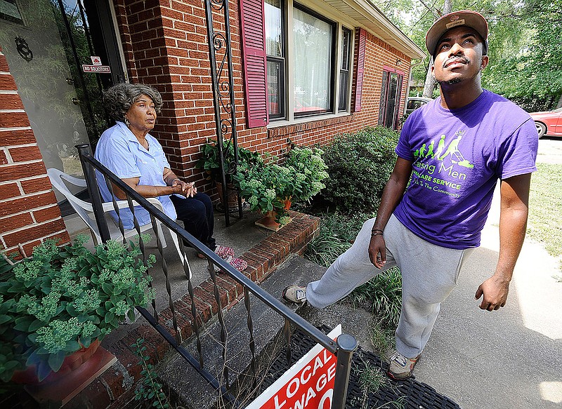 In this Saturday, Sept. 10, 2016 file photo, Rodney Smith Jr., founder of Raising Men Lawn Care Service, looks skyward while talking with homeowner Irene Renee Jolly in Huntsville, Ala. Smith Jr., who traveled to all 50 states to mow lawns for free says he's traveling across the country again to bring together police officers and the community. Rodney Smith Jr. tweeted Monday, August 12, 2019 to announce his tour called "Mowing with Cops" will start Wednesday August 14 in Apopka, Florida. (AP Photo/Jay Reeves, File)