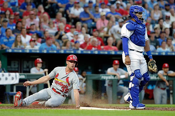 Lane Thomas of the Cardinals slides home to score on a single by Tommy Edman during the third inning of Tuesday night's game against the Royals at Kauffman Stadium.