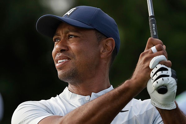 Tiger Woods tees off on the 12th hole last Thursday at the Northern Trust at Liberty National Golf Course in Jersey City, N.J.