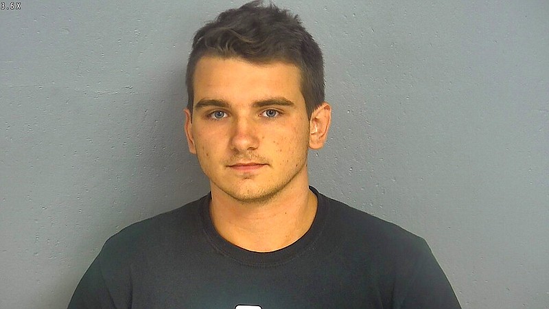 In this undated booking photo provided by the Greene County, Missouri, Sheriff's Office shows Dmitriy Andreychenko. Andreychenko, who walked into a Missouri Walmart with loaded weapons and wearing body armor acknowledges the timing was bad but says he doesn't regret his actions. Andreychenko is charged with making a terrorist threat after the Aug. 8 incident at a Walmart in Springfield. Shoppers fled and Andreychenko was held at gunpoint by an off duty firefighter before he was arrested (Greene County Sheriff via AP) .