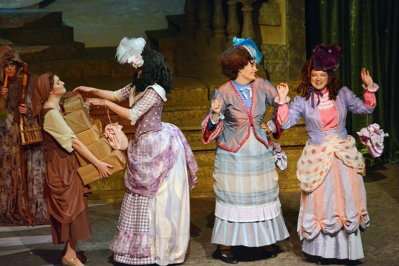 Ella, played by Amy Sneider, left, balances a stack of shopping boxes for her evil stepmother and two stepsisters Saturday, Aug. 10, 2019 during Rogers & Hammerstein's "Cinderella" at Capital City Productions. 