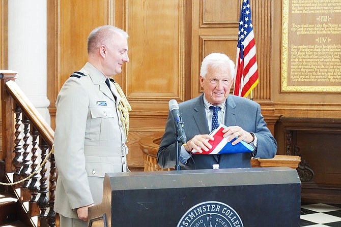 Comm. James Linter, left, Royal Air Force attaché, presents an RAF ensign to Fletcher Lamkin, president of Westminster College. The presentation was part of a special ceremony Wednesday in honor of World War II's Eagle Squadrons.