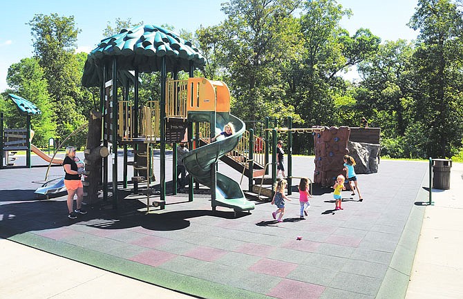 Children enjoy activities Thursday, Aug. 15, 2019, on the upper playground at Memorial Park. (News Tribune photo)