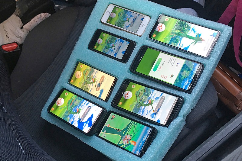 In this Tuesday, Aug. 13, 2019 photo provided by the Washington State Patrol, a piece of foam, cut to hold eight mobile phones in place -- all of them playing the game Pokemon Go -- is shown on the passenger seat of a vehicle driven by a person who was found pulled over on the shoulder of a highway in Washington state near Seattle by a Washington state trooper who thought the driver needed assistance. Trooper Rick Johnson, a spokesman for the patrol, and said the trooper did not issue a ticket because he did not observe the car moving while the driver was using the phones, but he did ask the driver to put the phones in the back seat and move along, as the shoulder is for emergencies only. (Sgt. Kyle Smith/Washington State Patrol via AP)