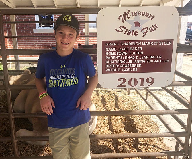 Gage Baker, 12, poses with his 2019 grand champion market steer at the Missouri State Fair. The steer weighed in at 1,325 pounds.