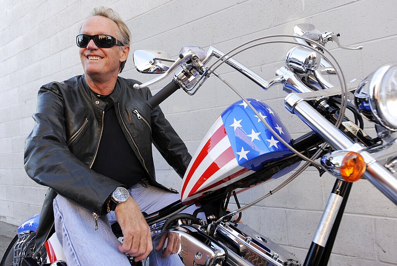 In this Friday, Oct. 23, 2009 file photo, Peter Fonda, poses atop a Harley-Davidson motorcycle in Glendale, Calif. Fonda, the son of a Hollywood legend who became a movie star in his own right both writing and starring in counterculture classics like "Easy Rider," has died. His family says in a statement that Fonda died Friday, Aug. 16, 2019, at his home in Los Angeles. He was 79. (Associated Press)