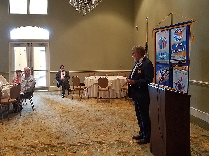 Jim Finstrom, right, a Rotary district governor, speaks to the Wilbur Smith Rotary Club on Thursday at Northridge Country Club in Texarkana, Texas.