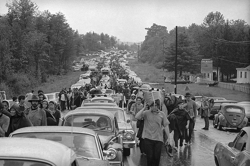 In this Aug. 16, 1969 file photo, hundreds of rock music fans jam a highway leading from Bethel, N.Y., as they try to leave the Woodstock Music and Art Festival. More than 400,000 people attended Woodstock which was staged 80 miles northwest of New York City on a bucolic hillside owned by dairy farmer Max Yasgur. It was great spot for peaceful vibes, but miserable for handling the hordes coming in by car. Fifty years later, memories of the rainy weekend Aug. 15-18, 1969 remain sharp among people who were in the crowd and on the stage. (AP Photo, File)