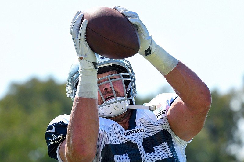 In this July 29, 2019, file photo, Dallas Cowboys tight end Jason Witten catches the ball from a passing machine at the NFL football team's training camp in Oxnard, Calif. The Cowboys and Los Angeles Rams meet Saturday, Aug. 17, 2019, in Honolulu, a place that used to be a regular NFL stop for the Pro Bowl. The first exhibition game in Hawaii since 1976 also figures to be Witten's return after a year in retirement as a broadcaster. (AP Photo/Michael Owen Baker, File)