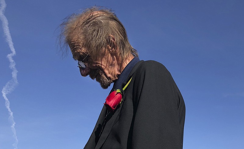 Antonio Basco, left, the long-time companion of Margie Reckard, 63,  speak to reporter Saturday, Aug. 17, 2019 in El Paso, Texas.  Hundreds of well-wishers gathered at an El Paso cemetery on Saturday to support  Basco as he buried his companion of 22 years.  Reckard was killed by a gunman who opened fire at an El Paso Walmart this month. (AP Photo/Russell Contreras)