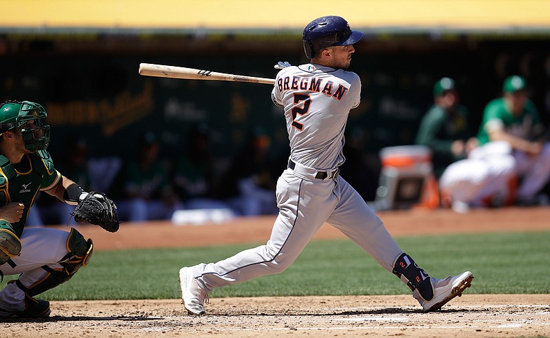 Houston Astros' Alex Bregman swings for an RBI-double off Oakland Athletics' Chris Bassitt in the third inning of a baseball game Saturday, Aug. 17, 2019, in Oakland, Calif. (AP Photo/Ben Margot)