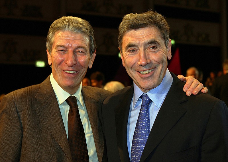 In this Saturday, Nov. 12, 2005 file photo, Former cycling World Champions Felice Gimondi, left, and Eddie Merckx, of Belgium pose for photographers before the start of the presentation of the 2006 edition of the 'Giro d' Italia' (Tour of Italy), in Milan, Italy. Gimondi died in Giardini Naxos, Sicily, southern Italy, Friday, Aug. 16, 2019, he was 76, Italian ANSA news agency said. (AP Photo/Luca Bruno, File)