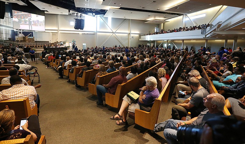  In this June 18, 2019 file photo people attend a community meeting in Phoenix. Still stinging from national outrage sparked this summer by a videotaped encounter of officers pointing guns and cursing at a black family, community members are holding low-key meetings aimed at helping Phoenix officials figure out how citizens could help oversee the city's officers. (AP Photo/Ross D. Franklin,File)