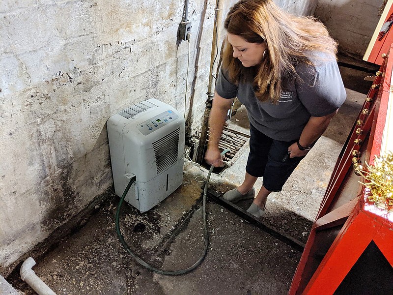 Tamara Tateosian, Callaway Chamber of Commerce executive director, points out standing water in the basement at 510 Market St. The building also lacks commercial dehumidifiers and a closed sump-pump system. The chamber and the Fulton Area Development Foundation are requesting fixes from the city before renewing the building's lease.