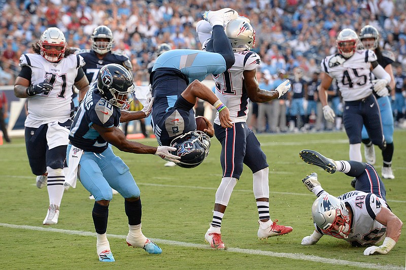 Tennessee Titans quarterback Marcus Mariota (8) flips into the end zone as he converts a 2-point conversion against the New England Patriots in the first half of a preseason NFL football game Saturday, Aug. 17, 2019, in Nashville, Tenn. (AP Photo/Mark Zaleski)