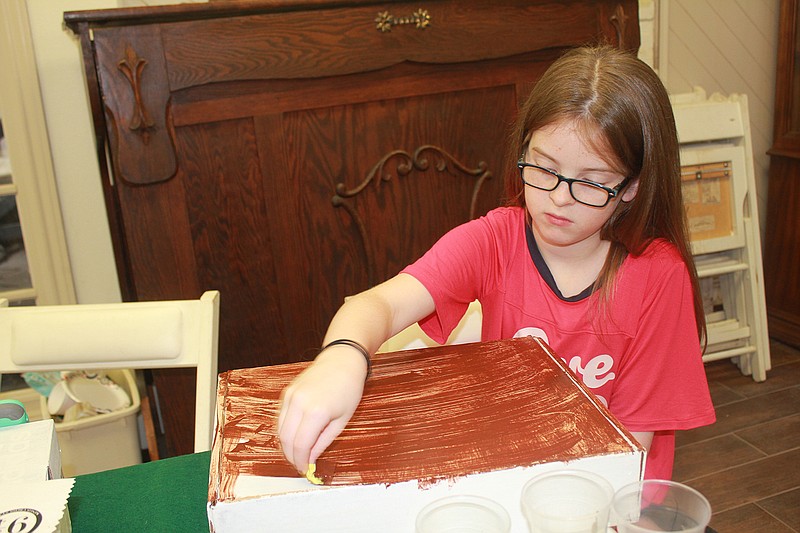 Raeleigh Beard, member of a family of Harry Potter fans, puts together her travel trunk Saturday at the Ace of Clubs House as the Beard family continues their enchanted adventure during Harry Potter month.