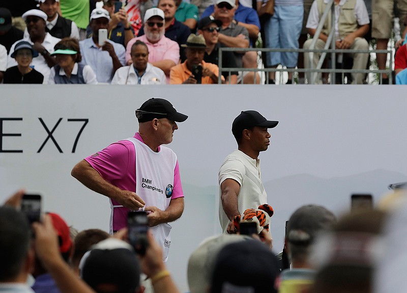 Tiger Woods, right, and his caddie, Joe LaCava looks to the first hole fairway during the second round of the BMW Championship golf tournament at Medinah Country Club, Friday, Aug. 16, 2019, in Medinah, Ill. (AP Photo/Nam Y. Huh)