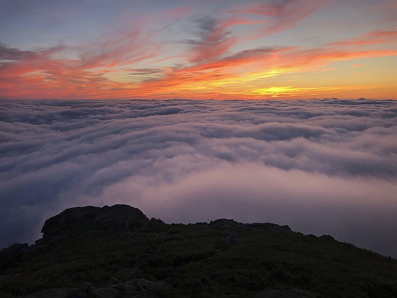 This photo taken by Philip Carcia on Aug. 30, 2018, shows the sunset from Mount Jefferson, one of 48 mountains in New Hampshire with summits higher than 4,000 feet.  On July 7, Carcia became only the second hiker to cram the grid into a single year, finishing in 319 days and beating the previous record by five weeks. He says he sees himself not as a conqueror but a pioneer, giving himself to the mountains he loves. (Philip Carcia via AP)