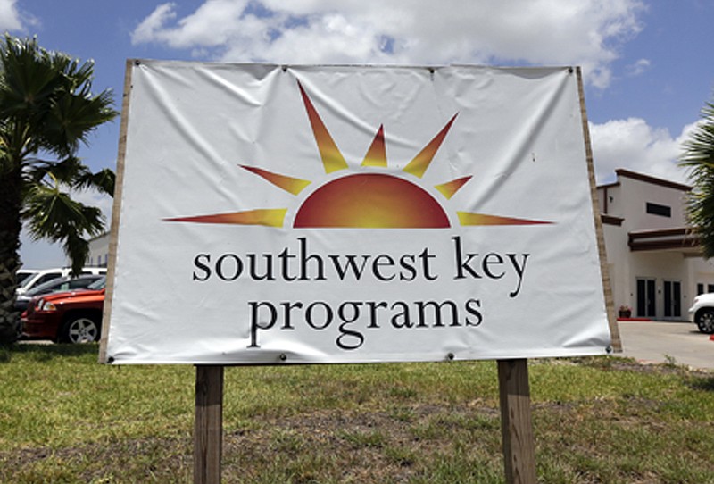 FILE - This June 20, 2014, file photo, shows a Southwest Key program sign in Brownsville, Texas. A provider of shelters for immigrant children is looking to reopen two facilities that the state of Arizona forced it to shutter last year because of issues with employee background checks and allegations of abuse. Southwest Key has filed applications to reopen a facility in downtown Phoenix and one in an outer suburb where employees were investigated for child abuse but never charged. The nonprofit filed the applications in June and July. (AP Photo/Eric Gay, File)