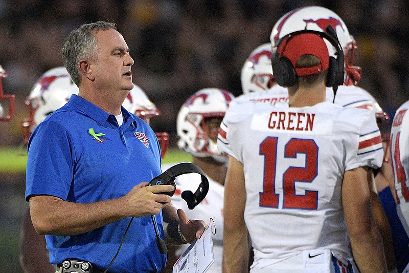 SMU head coach Sonny Dykes, left, talks to his players Oct. 6, 2018, during a timeout in the first half of an NCAA football game against Central Florida in Orlando, Fla. Best to expect the unexpected in the AAC. The league has been fertile ground for fast turnarounds since it rose from the ashes of the old Big East in 2013. SMU under second-year coach Dykes was in the thick of the West Division race last season until losing its last two. The Mustangs add former Texas quarterback Shane Buechele, among several transfers who could give SMU more staying power.