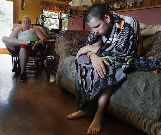 In this Monday, July 29, 2019 photo, Dylan Nelson, of Burlington, Wis., and his sister, Andrea, sit for an interview. He was rushed to the hospital in June by his sister last month with severe breathing problems. Doctors believe he and about two dozen other young adults suffered serious lung injuries after vaping nicotine or THC, or both. (Rick Wood/Milwaukee Journal Sentinel via AP)