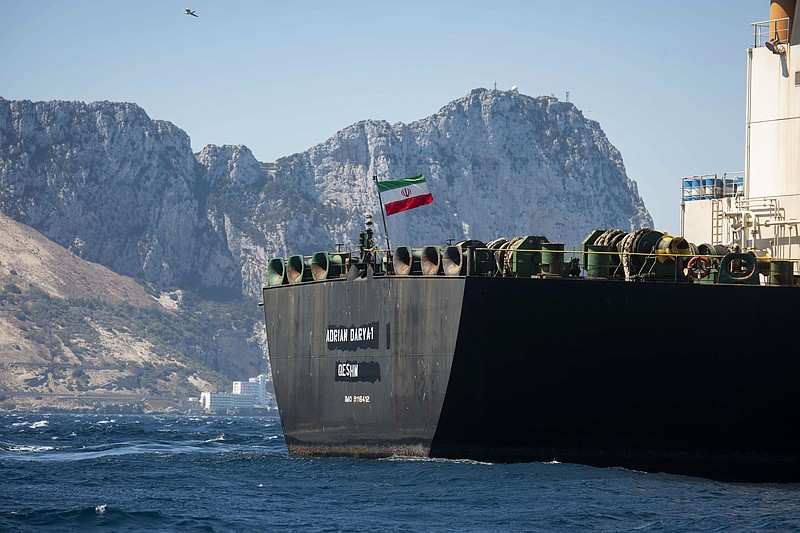 Renamed Adrian Aryra 1 super tanker hosting an Iranian flag sails in the waters in the British territory of Gibraltar, Sunday, Aug. 18, 2019. Authorities in Gibraltar on Sunday rejected the United States' latest request not to release a seized Iranian supertanker, clearing the way for the vessel to set sail after being detained last month for allegedly attempting to breach European Union sanctions on Syria. (AP Photo/Marcos Moreno)