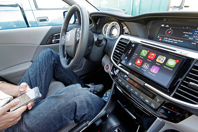 The Apple CarPlay app is shown on Oct. 23, 2015,   during a test drive of a 2016 Honda Accord in Hayward, Calif.   Amazon is trying to persuade automakers to bake its voice-activated digital assistant into their entertainment systems, entering a market already contested by Google and Apple. 

