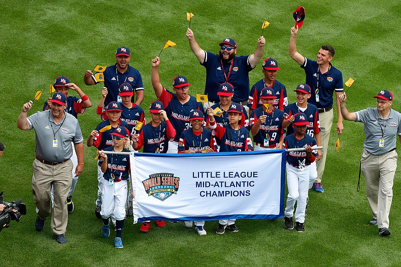 The Mid-Atlantic Region Champion Little League team from Elizabeth, N.J., participates in the opening ceremony of the 2019 Little League World Series baseball tournament on Thursday in South Williamsport, Pa. With each game it plays at the Little League World Series, the Elmora Youth League team shares the memory of Thomas Hanratty, a state trooper who was killed during a traffic stop in 1992.