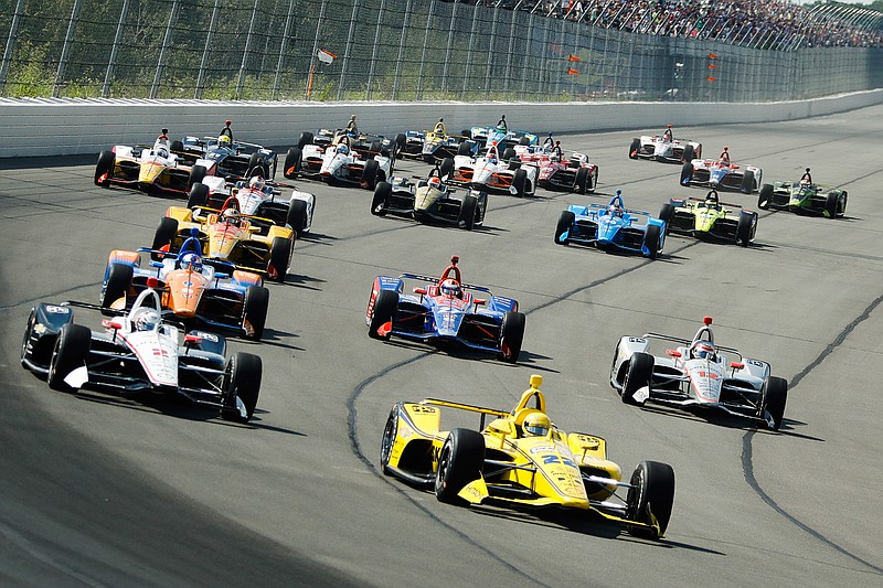  Drivers led by Simon Pagenaud (22) enter Turn 1 after taking the green flag to start the IndyCar Series auto race Sunday at Pocono Raceway in Long Pond, Pa. 