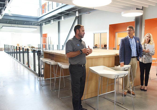 Capital City High School Principal Ben Meldrum, left, talks about the open area in the new school and the opportunity for teachers and students to be able to collaborate on projects and lessons. He lead a group through CCHS on a media tour Tuesday afternoon so the extent of progress could be seen. At right is Jason Hoffman, Jefferson City Public Schools Chief of Operations and Ryan Burns, director of communications for the district. 