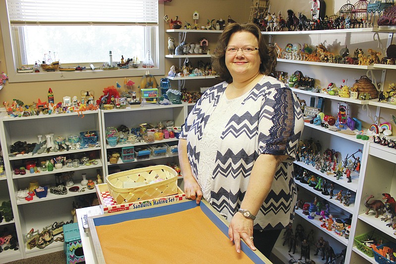 <p>Democrat photo/Austin Hornbostel</p><p>Registered Play Therapist-Supervisor Cathy Figgins stands next to her office’s sandtray, figures and statuettes filling the background. Figgins was awarded the Kathryn Boone Outstanding Play Therapist Award by the Missouri Association for Play Therapy (MAPT) last June.</p>
