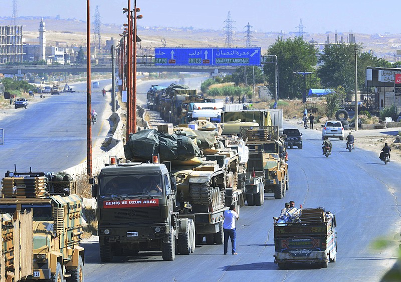 A Turkey Armed Forces convoy is seen at a highway between Maaret al-Numan and Khan Sheikhoun in Idlib province, Syria, Monday, Aug. 19, 2019. The Turkish Defense Ministry says airstrikes have targeted a Turkish military convoy in Syria, killing at least three civilians and wounding 12 others in Monday's attack that occurred while the convoy was heading toward a Turkish observation post in the rebel-held stronghold of Idlib. (Murat Kibritoglu/DHA via AP)