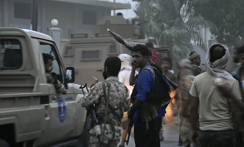 In this Friday Aug. 9, 2019 frame grab from video, Southern Transitional Council separatist fighters head toward the presidential palace in the southern port city of Aden, Yemen. The separatists backed by the United Arab Emirates began withdrawing Sunday from positions they seized from the internationally-recognized government in Aden. Both the southern separatists and the government forces are ostensibly allies in the Saudi-led military coalition that’s been battling the Houthi rebels in northern Yemen since 2015, but the four days of fighting in Aden have exposed a major rift in the alliance. (AP Photo)
