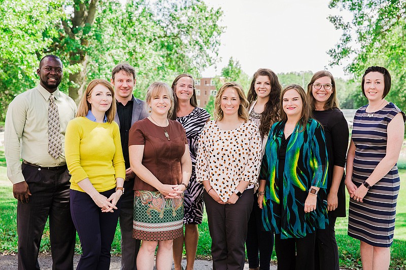 New William Woods University faculty pose on WWU's verdant campus. Newly hired faculty members include: Back row, from left, Charles DoDoo, Joshua Turkewitz, Jessica Mannion, Baily McCallum, Rachel Deutmeyer and Ellen Moore. Front row includes, from left, Bethanie Irons, Valerie Wedel, Mary Placzkowski and Kristee Lorenz.